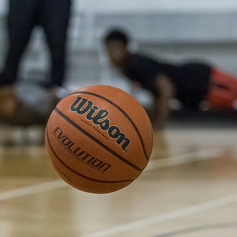 girl kneeling holding basketball