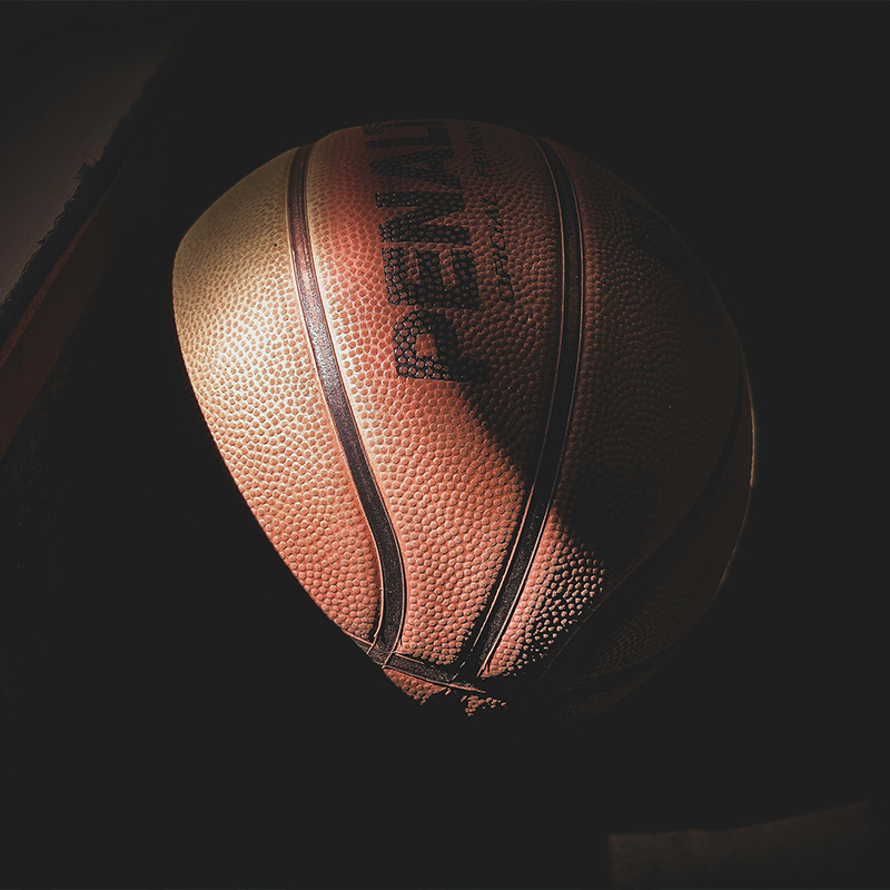 girl kneeling holding basketball