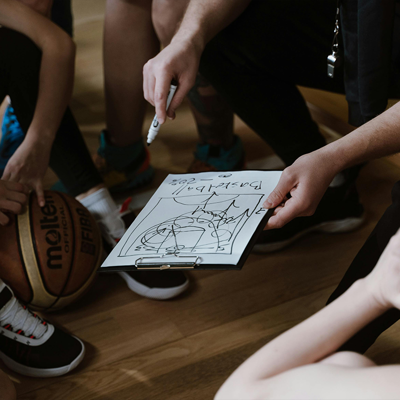 girl kneeling holding basketball